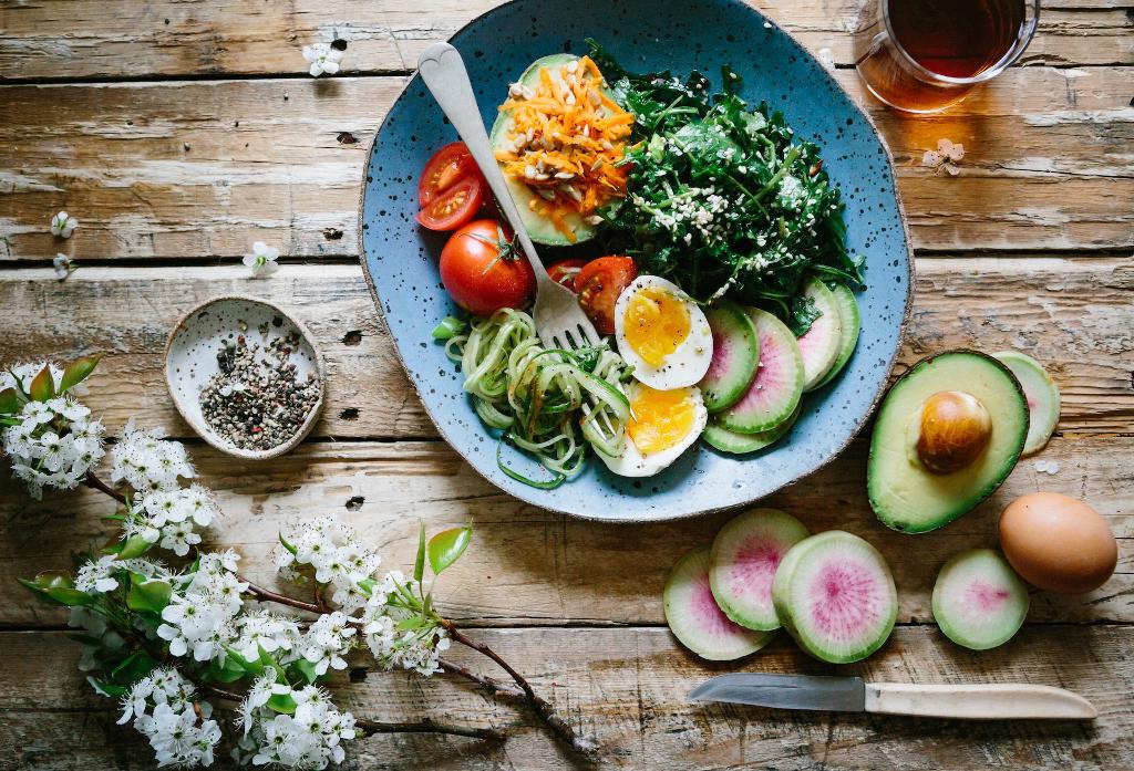 Potassium in Sports Nutrition: Benefits and Best Products poached egg with vegetables and tomatoes on blue plate