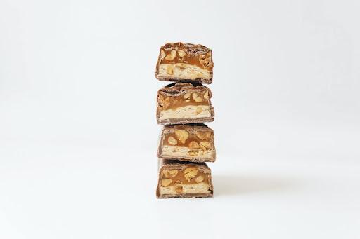 A pile up of energy bars with peanut and caramel